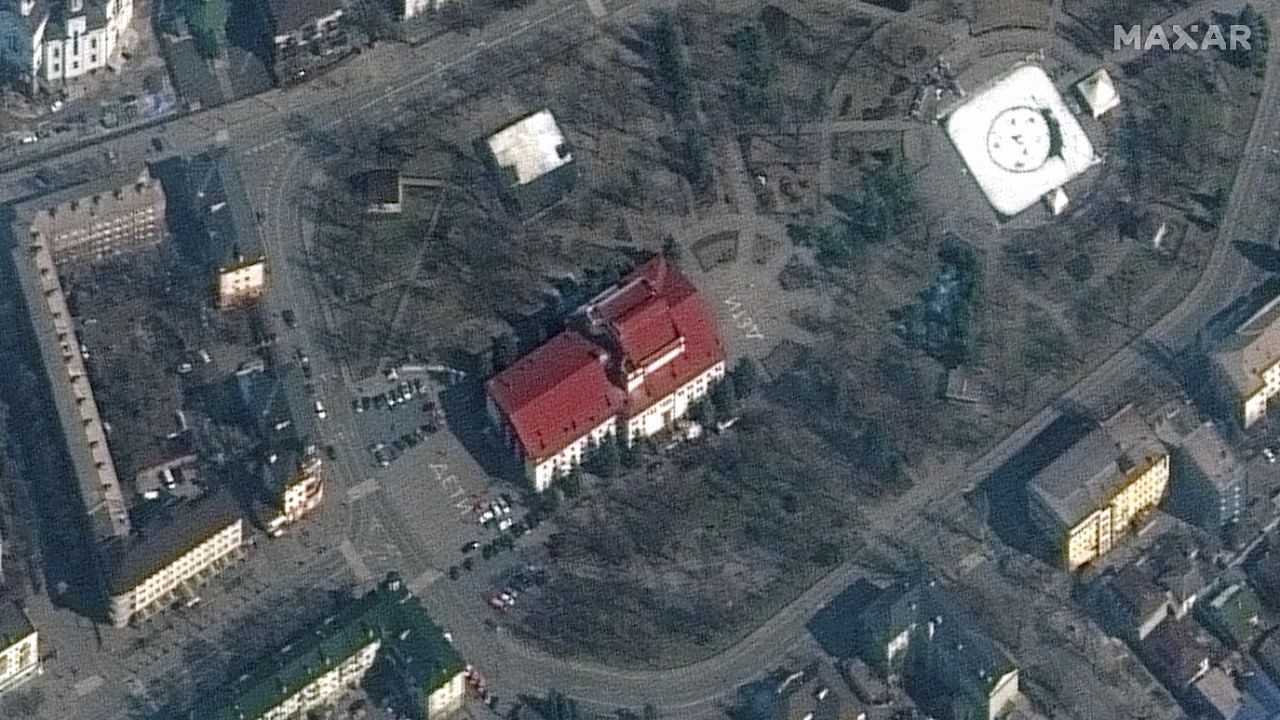 A satellite image shows a closer view of Mariupol Drama Theatre before bombing, as a word "children" in Russian is written in large white letters on the pavement in front of and behind the building, in Mariupol. Credit: Reuters photo/Maxar