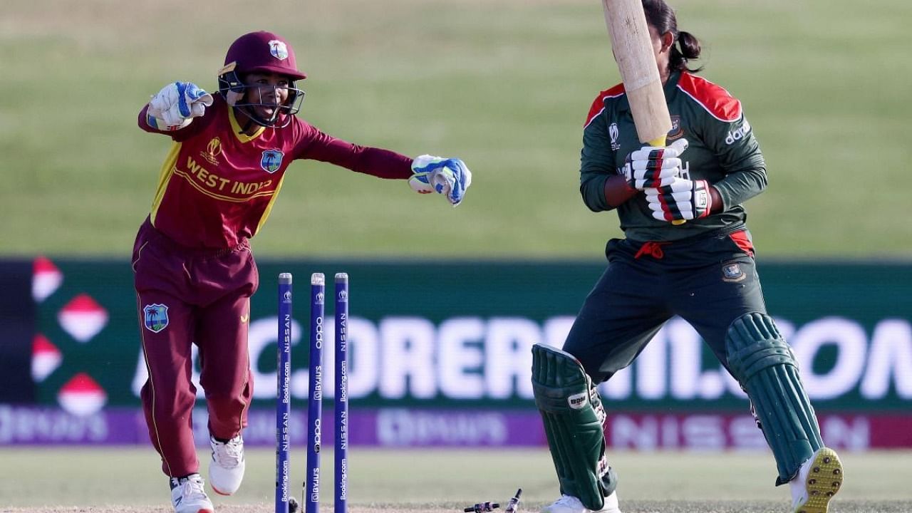 West Indies wicketkeeper Shemaine Campbelle (L) celebrates the final wicket of Bangladesh's Fariha Trisna (R) during the 2022 Women's Cricket World cup match between the West Indies and Bangladesh at Bay Oval in Tauranga. Credit: AFP Photo