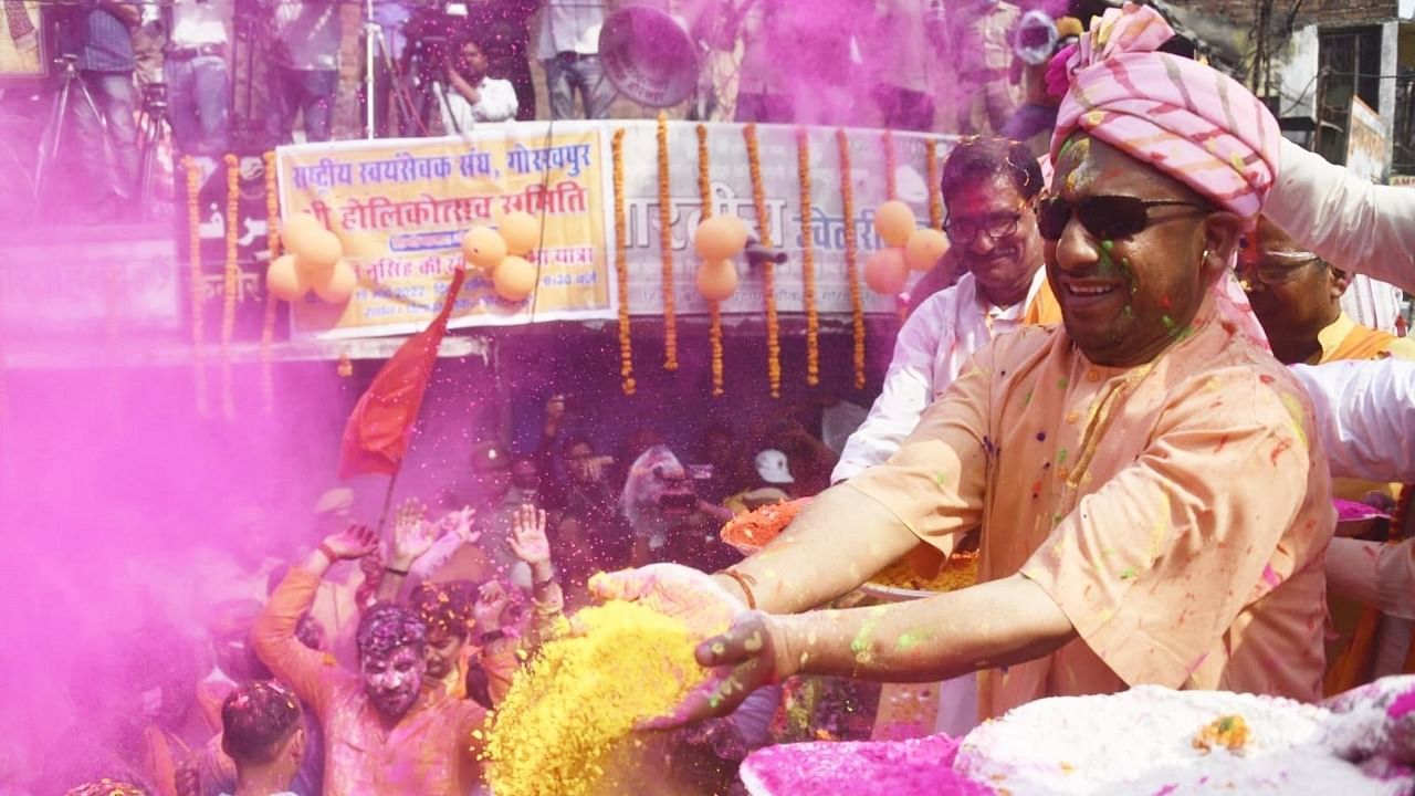 Uttar Pradesh Chief Minister Yogi Adityanath plays with colour powder on the occasion of Holi festival in Gorakhpur on Saturday, March 19, 2022. Credit: IANS Photo