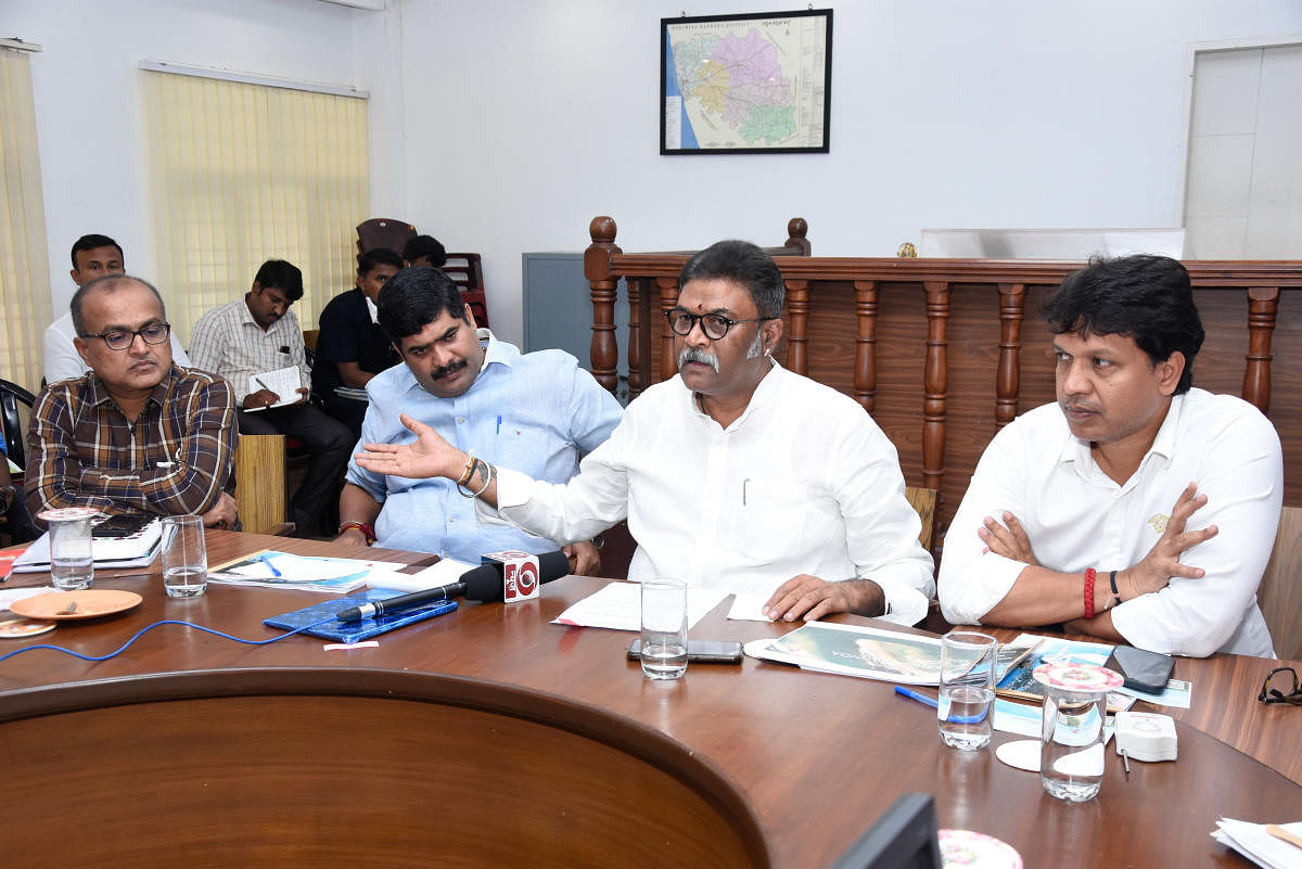 Minister of Tourism, Ecology and Environment Anand Singh speaks to reporters after chairing a review meeting at the DC's office in Mangaluru.