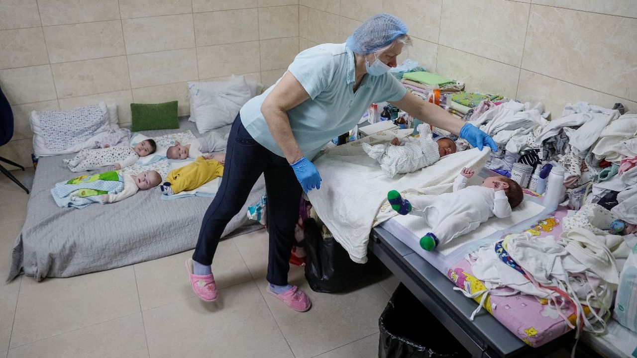 A nurse looks after surrogate-born babies inside a special shelter owned by BioTexCom clinic in a residential basement, as Russia's invasion continues, on the outskirts of Kyiv, Ukraine March 15, 2022. Credit: Reuters Photo