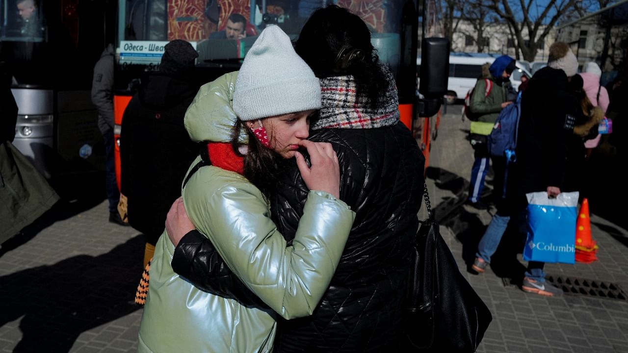 Angelica Honcharenko, 49, from Kyiv, hugs her daughter Albina, 11, after fleeing Russia's invasion of Ukraine, before they board a bus heading to Dusseldorf, in Germany outside the train station in Lviv, Ukraine March 20, 2022. Credit: Reuters Photo