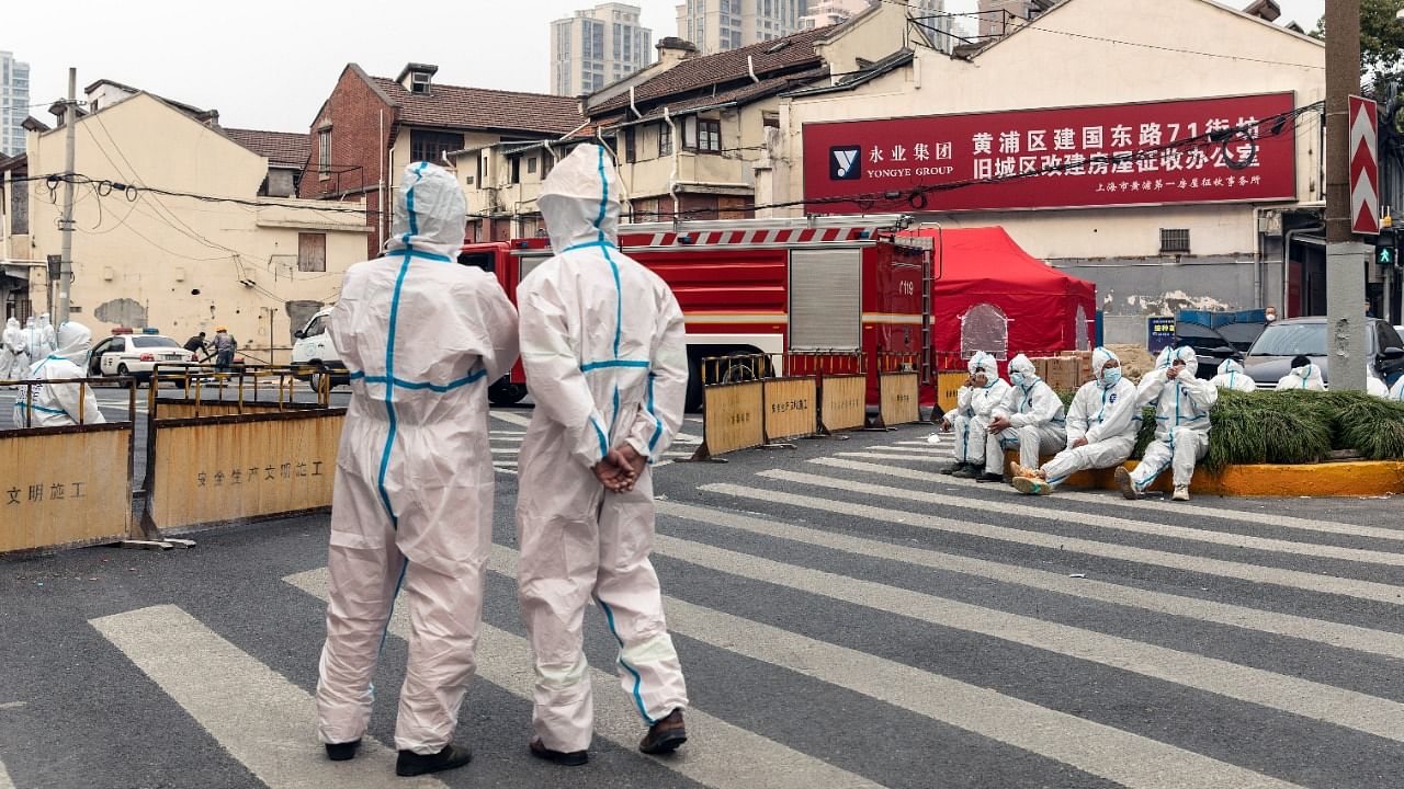 Healthcare workers outside a locked zone in China's Shanghai. Credit: The New York Times Photo