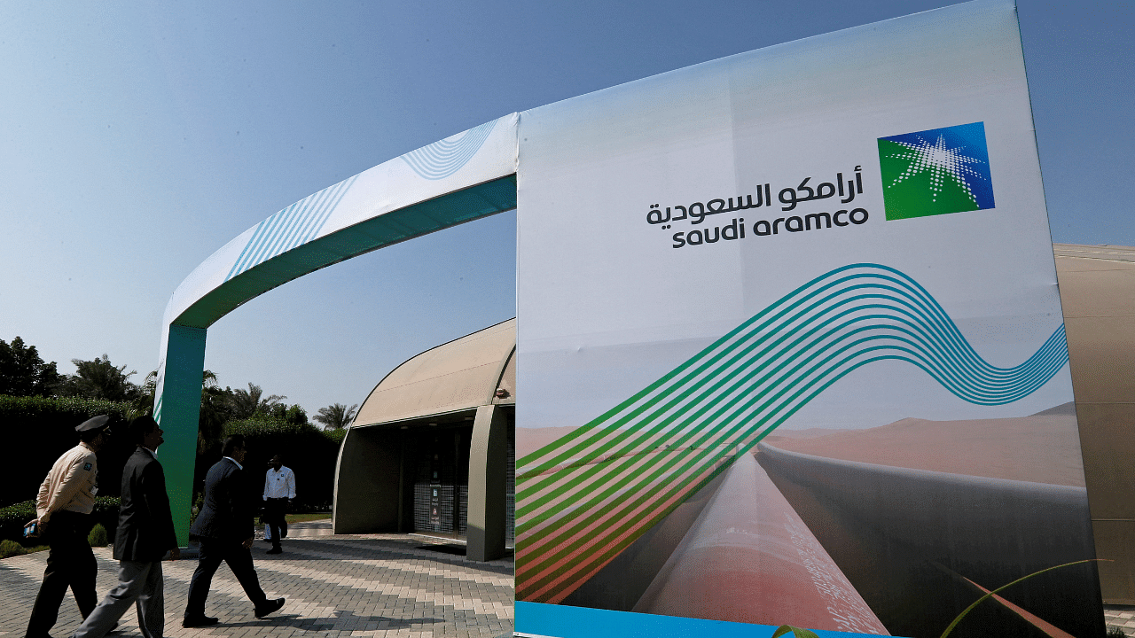 Logo of Aramco is seen as security personnel walk before the start of a press conference by Aramco. Credit: Reuters Photo