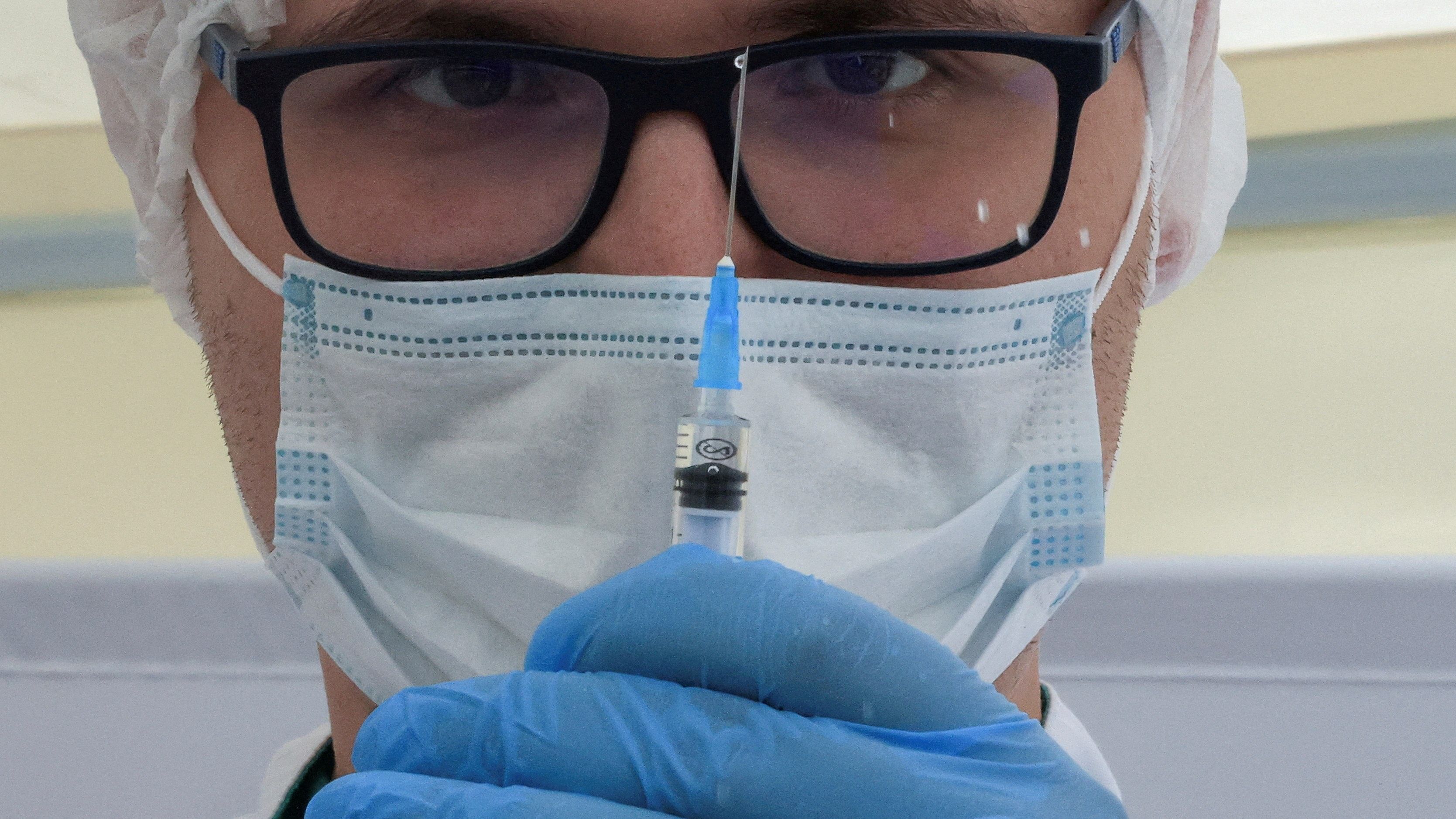 A healthcare worker holds a syringe with the one-dose Sputnik Light. Credit: Reuters File Photo