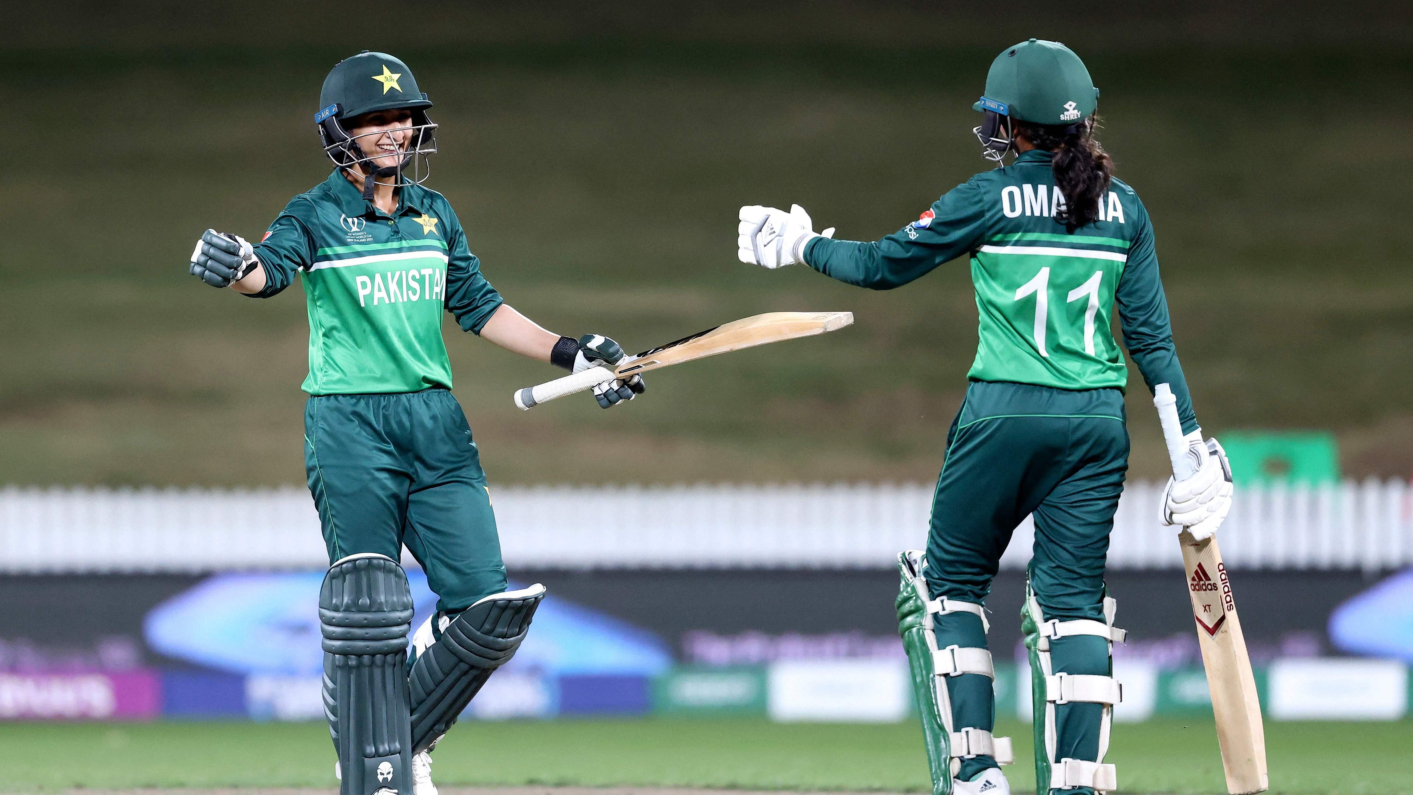 Pakistan's Bismah Maroof (L) and Omaima Sohail (R) celebrate winning the match during the 2022 Women's Cricket World Cup match between Pakistan and West Indies at Seddon Park. Credit: AFP Photo