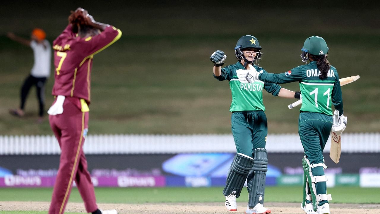 Pakistan's Bismah Maroof (C) and Omaima Sohail (R) celebrate winning their 2022 Women's Cricket World Cup match against West Indies at Seddon Park in Hamilton. Credit: AFP Photo