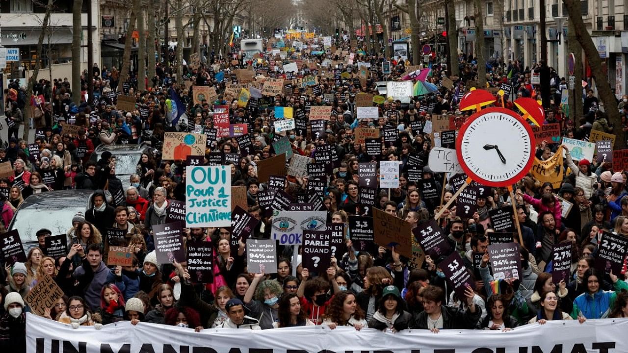 Protesters march in Paris to urge governments to act against climate change and social injustice. Credit: Reuters File Photo