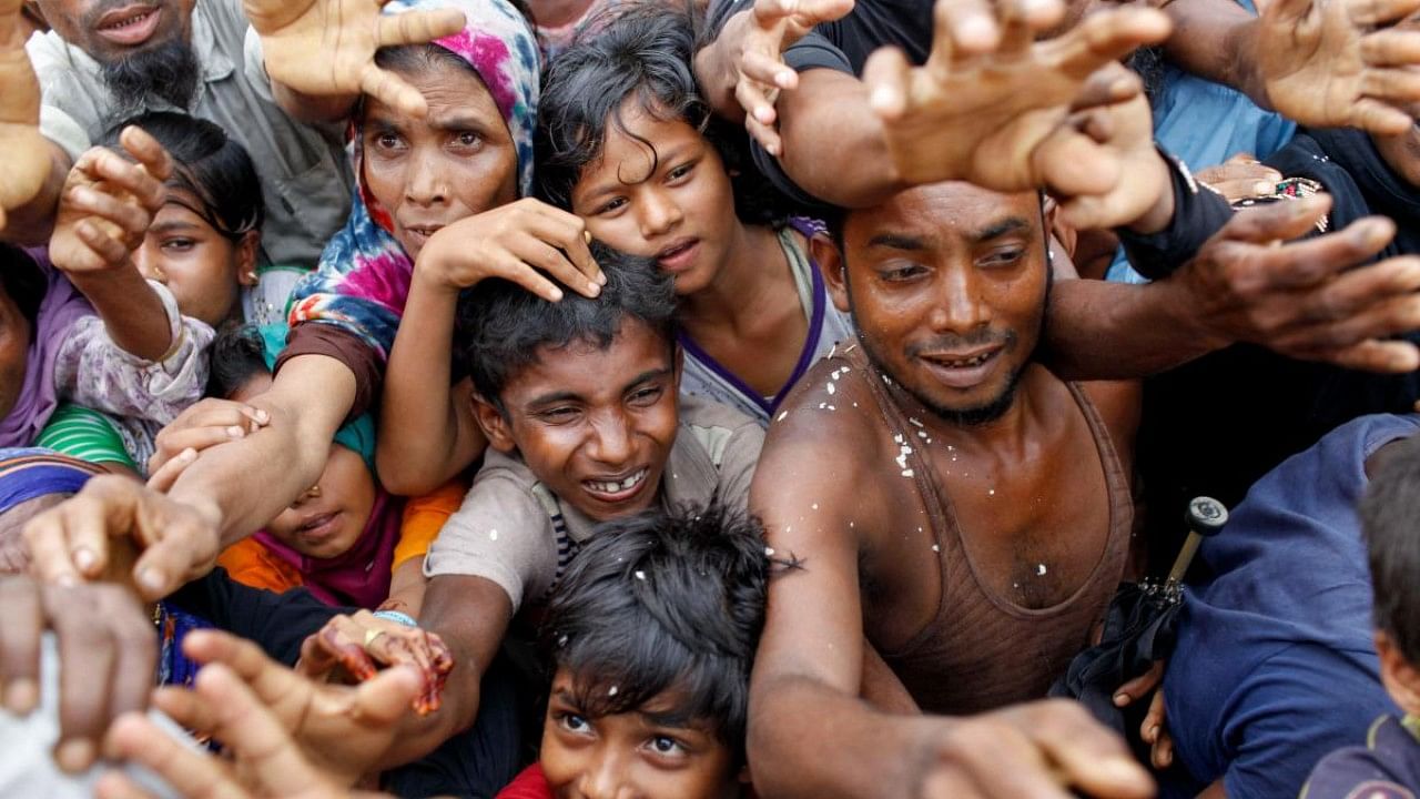 Rohingya refugees from Myanmar's Rakhine state wait for aid at Kutupalong refugee camp in the Bangladeshi town of Teknaf. Credit: AFP File Photo