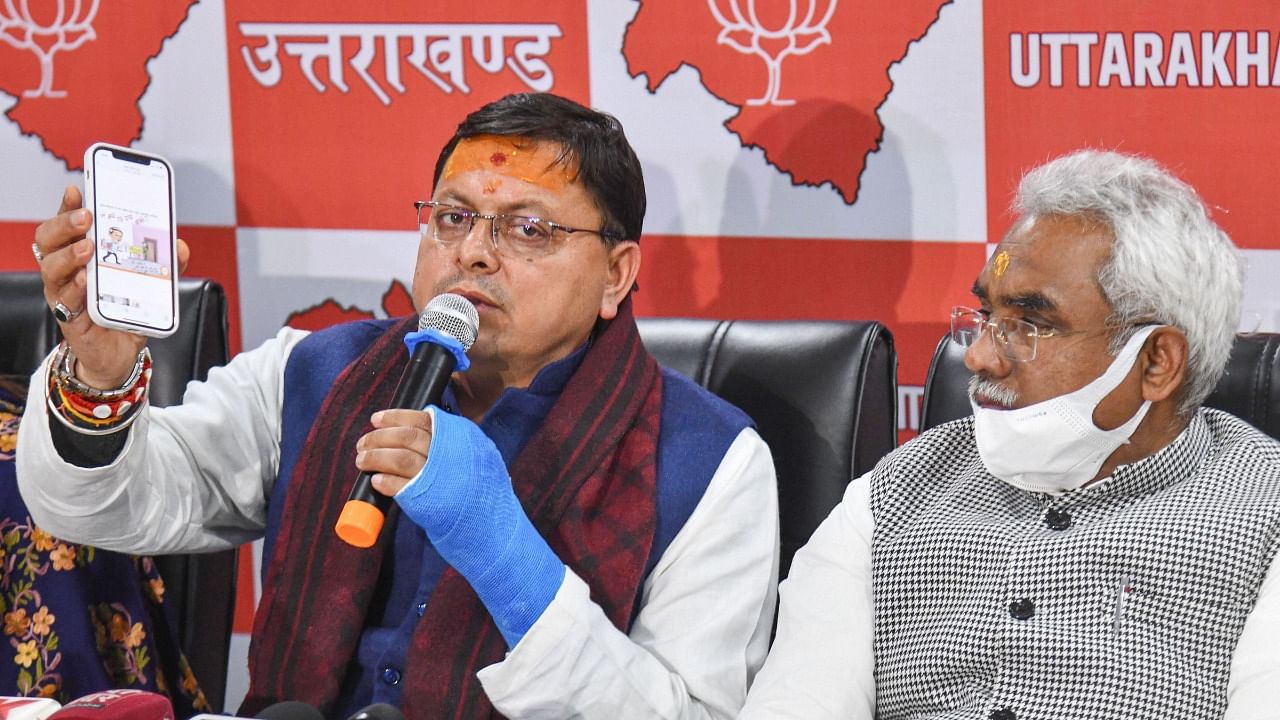 Pushkar Singh Dhami (L) during a press conference in the rup-up to the elections. Credit: PTI File Photo