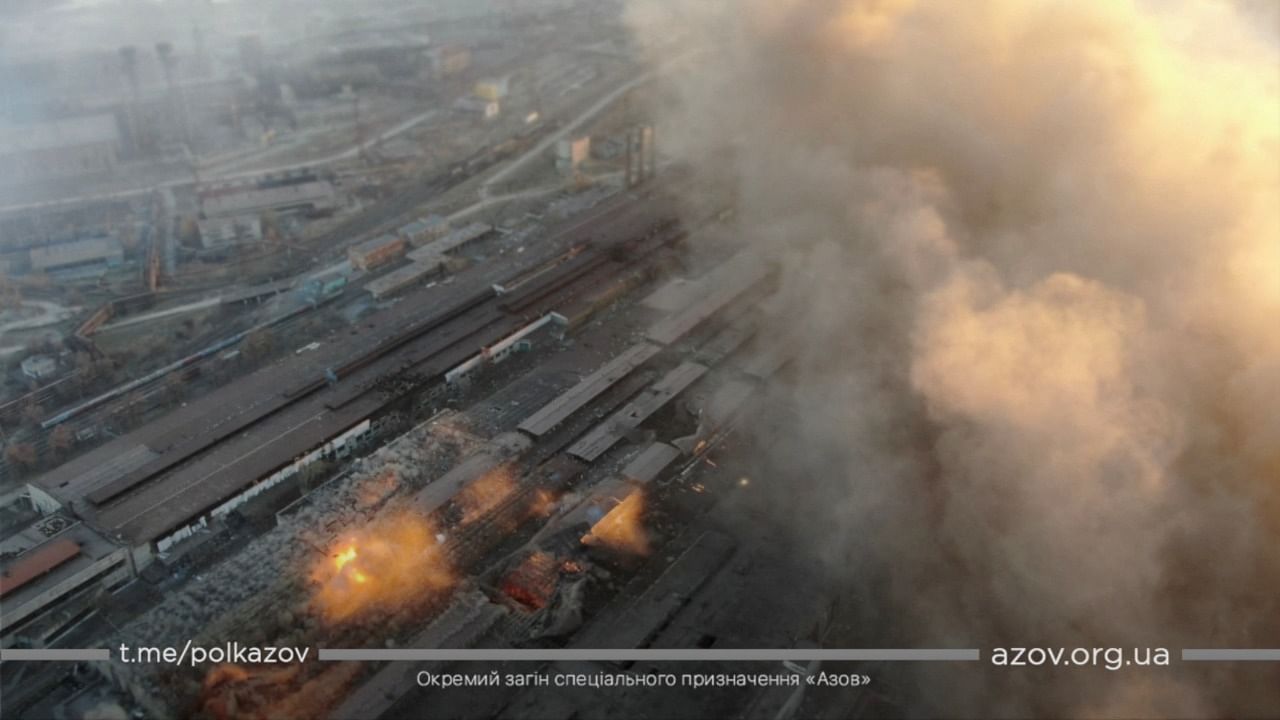 Multiple explosions and rising smoke are seen around an industrial compound, in Mariupol. Credit: AZOV/Handout via Reuters