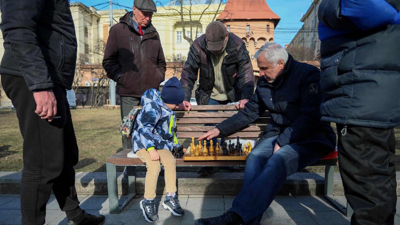 Men play chess at a bench on the central promenade in the western Ukrainian city of Lviv. Credit: AFP Photo