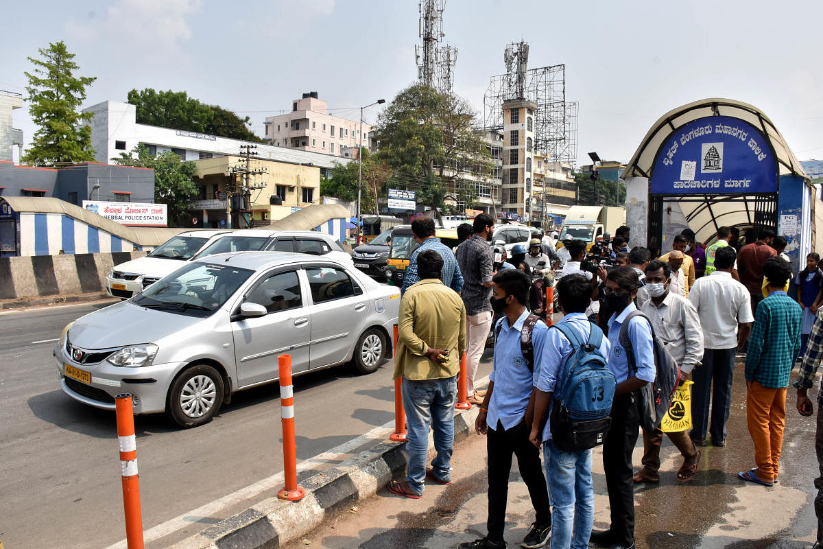 People gather at the accident spot where the class 9 student died while she was crossing the road at the busy Airport Road in Hebbal. Credit: DH Photos/B K Janardhan