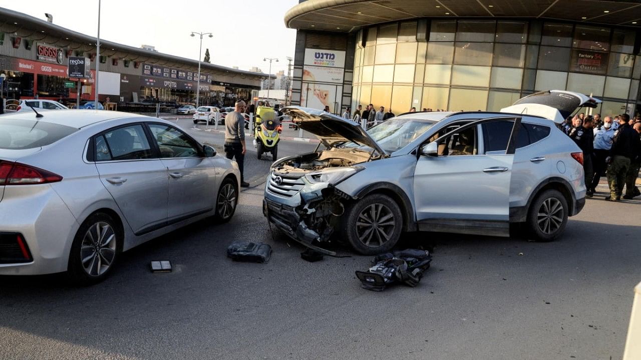 The wreckage of a car is seen at the scene of an attack in a shopping area in which people were killed near a shopping centre in Beersheba. Credit: Reuters Photo