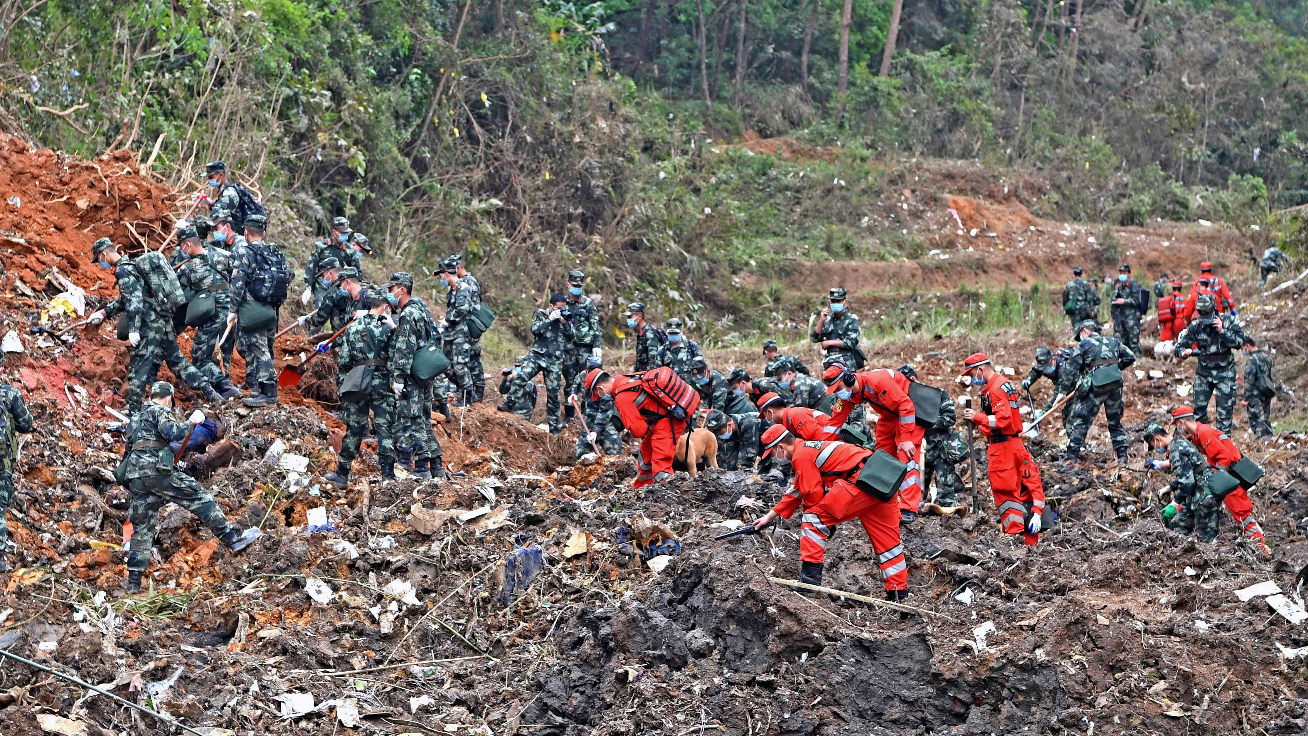  In this photo released by Xinhua News Agency, rescue workers search for the black boxes at a plane crash site in Tengxian county, southwestern China's Guangxi Zhuang Autonomous Region. Credit: AP Photo