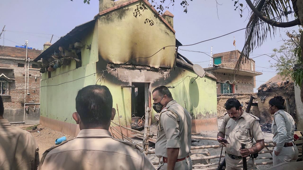 Police personnel near the houses that were set on fire by some miscreants allegedly for avenging the killing of TMC leader Bhadu Sheikh, at Rampurhat in Birbhum district. Credit: PTI Photo