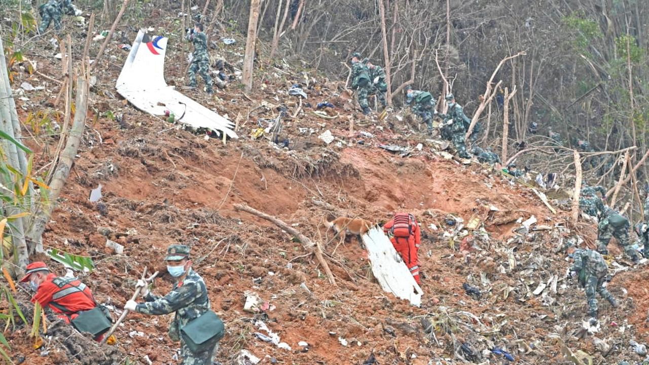 Rescuers search for the black boxes at a plane crash site in Tengxian county of Wuzhou, Guangxi Zhuang Autonomous Region, China March 22, 2022. Credit: Reuters Photo