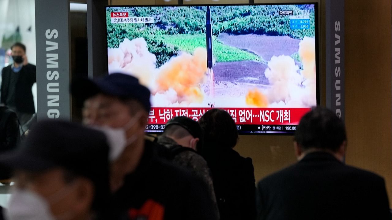 People watch a TV showing a file image of North Korea's missile launch during a news program at the Seoul Railway Station in Seoul. Credit: AFP Photo