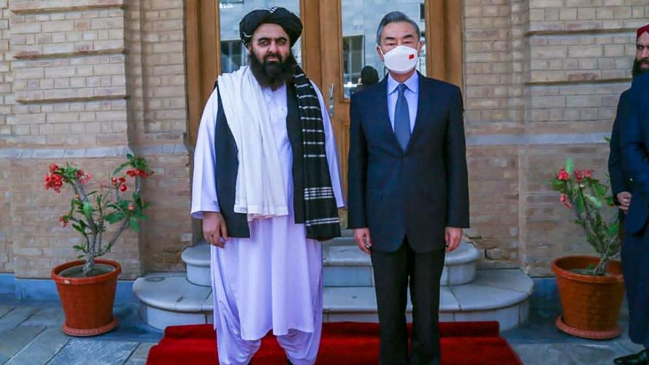 Handout photo released by the Taliban Foreign Ministry shows Taliban Foreign Minister Amir Khan Muttaqi (L) posing with China's Foreign Minister Wang Yi in Kabul. Credit: AFP Photo