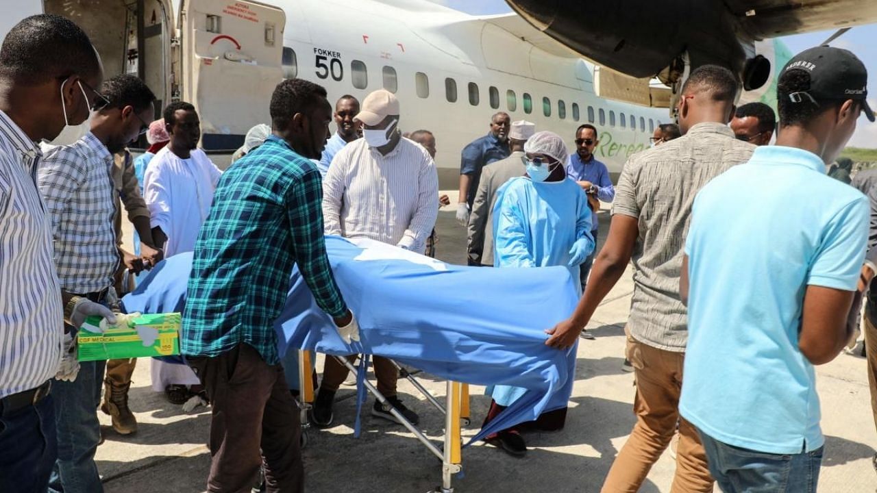 People unload the body of the local lawmaker after she was killed by a suicide bombing attack in Beledweyne, at Aden Adde International Airport in Mogadishu, Somalia. Credit: AFP Photo