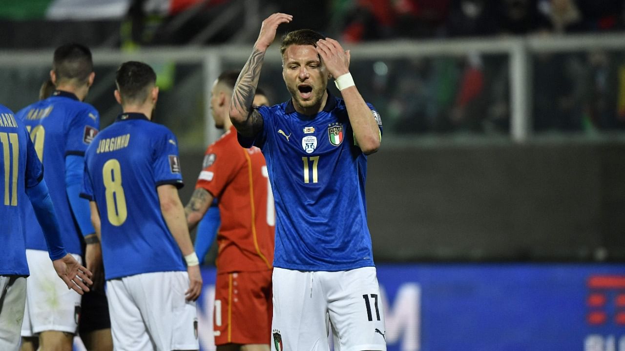 Italian players react after losing a crucial qualifying match. Credit: AFP Photo