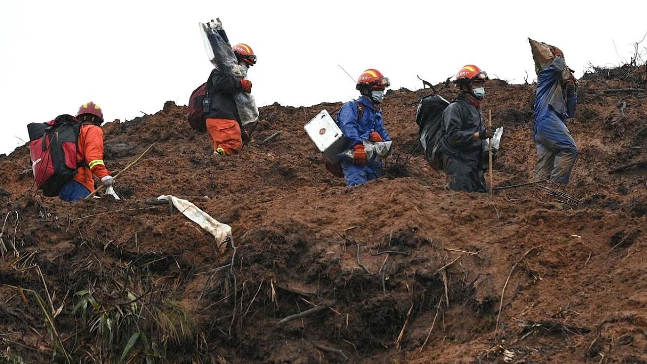 Rescue workers comb through the site of where China Eastern flight MU5375 crashed on March 21, near Wuzhou in southwestern China’s Guangxi province. Credit: AFP Photo