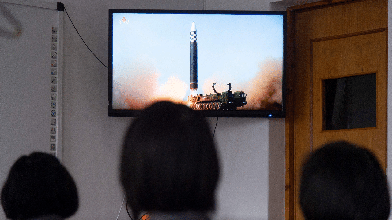 Students of the Pyongyang Jang Chol Gu University of Commerce watch footage of the previous day's launch of the Hwasong-17 missile. Credit: AFP Photo