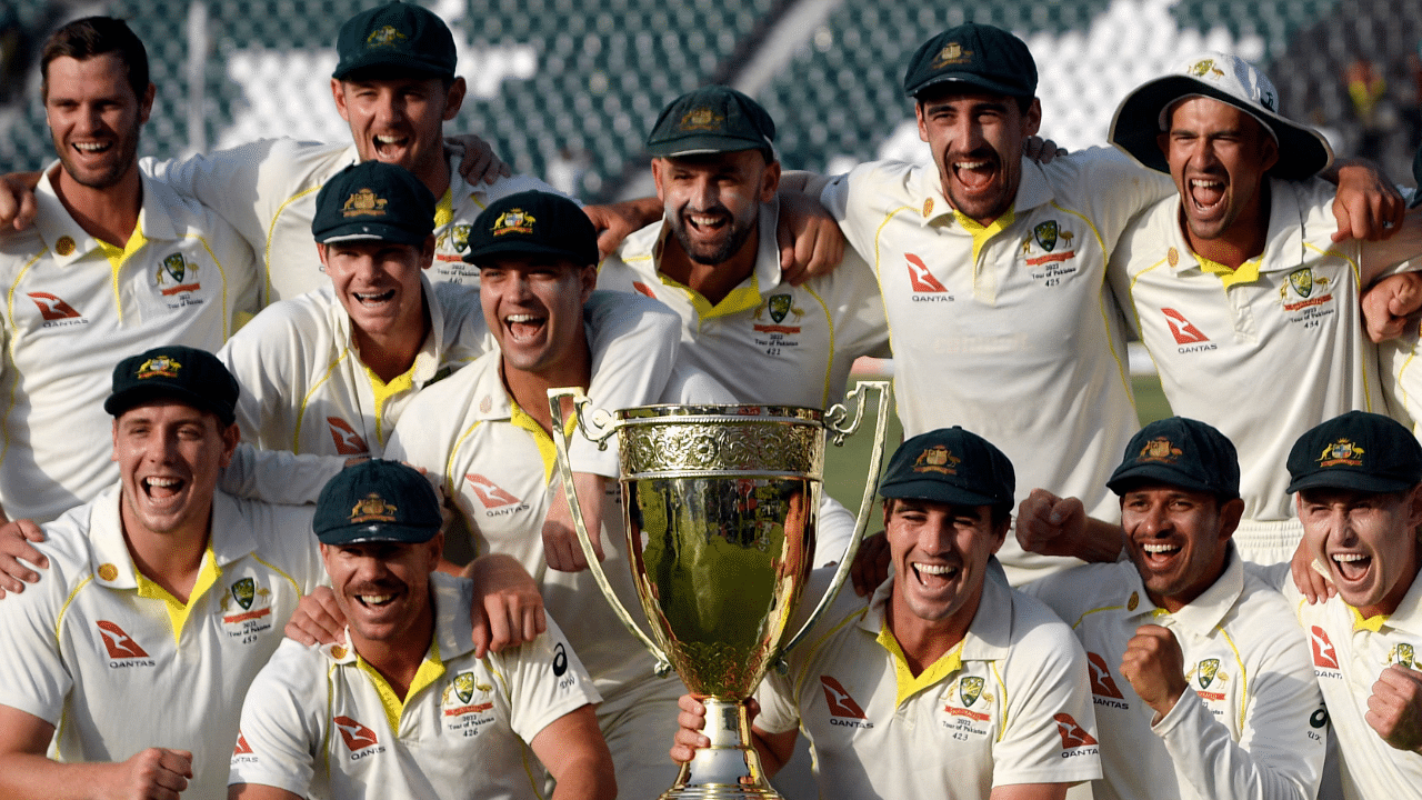 Australia's players pose with the trophy after winning the third and final Test cricket match against Pakistan. Credit: AFP Photo
