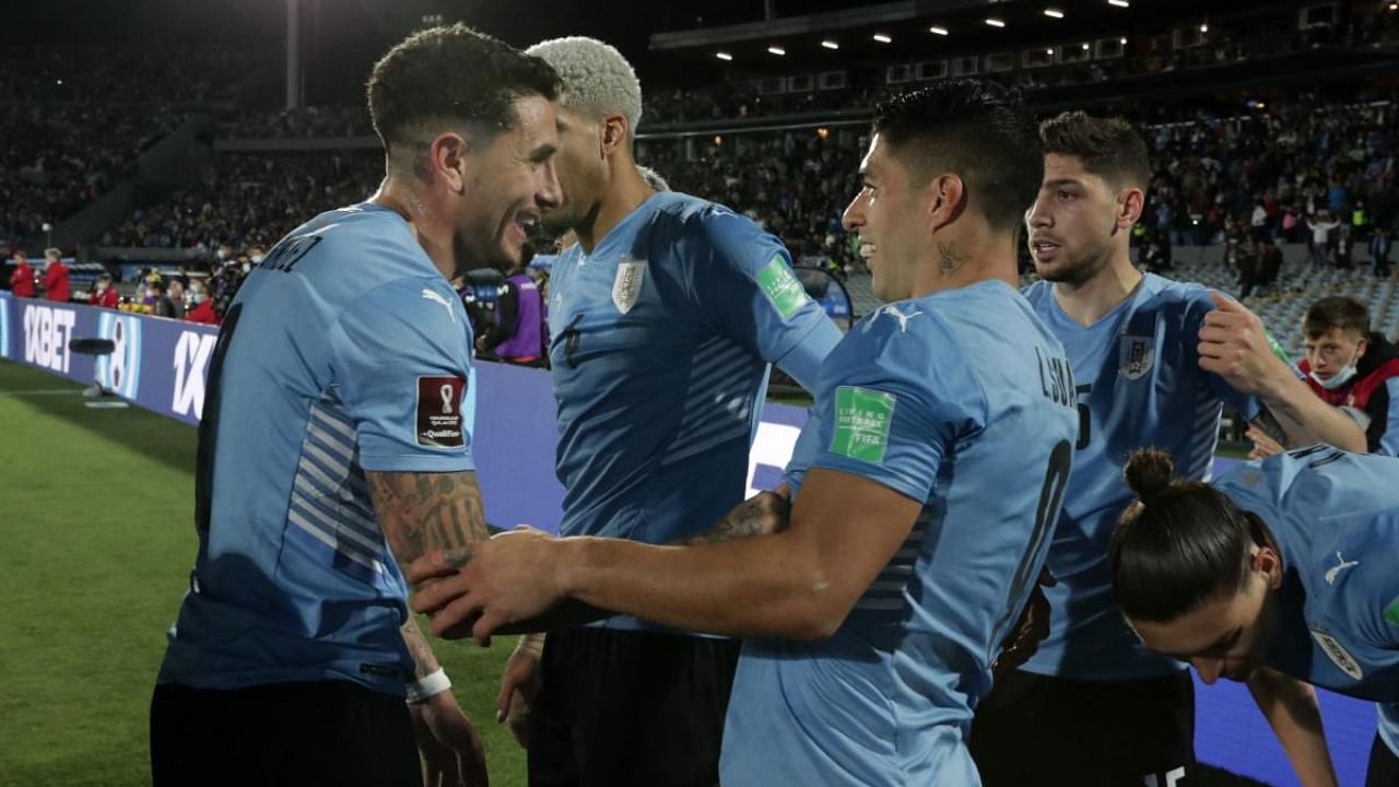 Uruguayan players celebrate after Giorgian De Arrascaeta's goal against Peru during their South American qualification football match for the FIFA World Cup Qatar 2022. Credit: AFP Photo