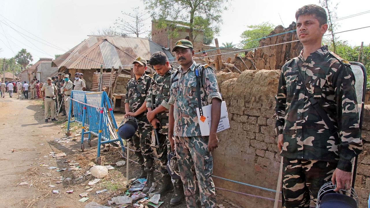 Security personnel stand guard in the area where violence broke out. Credit: PTI Photo