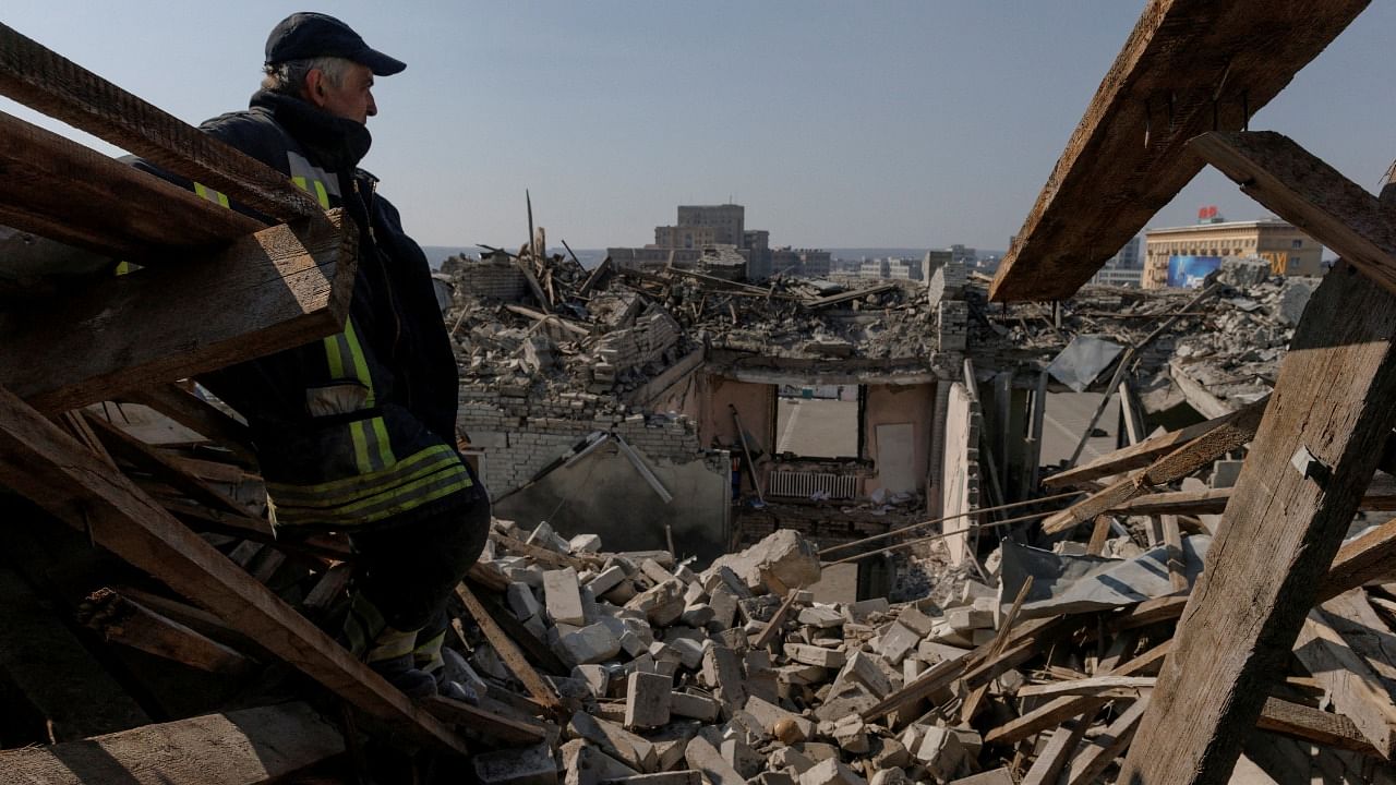 A Ukrainian stands amid the debris of shelled buildings in Kharkiv. Credit: Reuters Photo