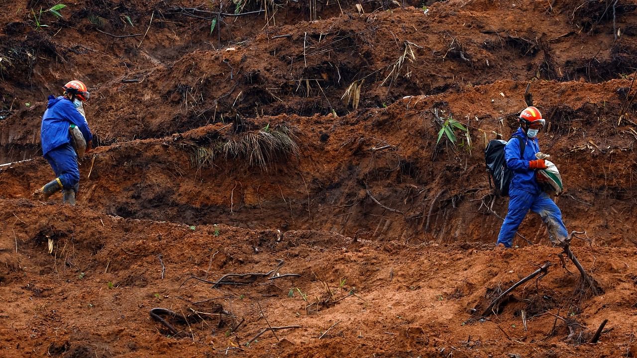 Rescue workers walk at the site where a China Eastern Airlines Boeing 737-800 plane. Credit: Reuters Photo