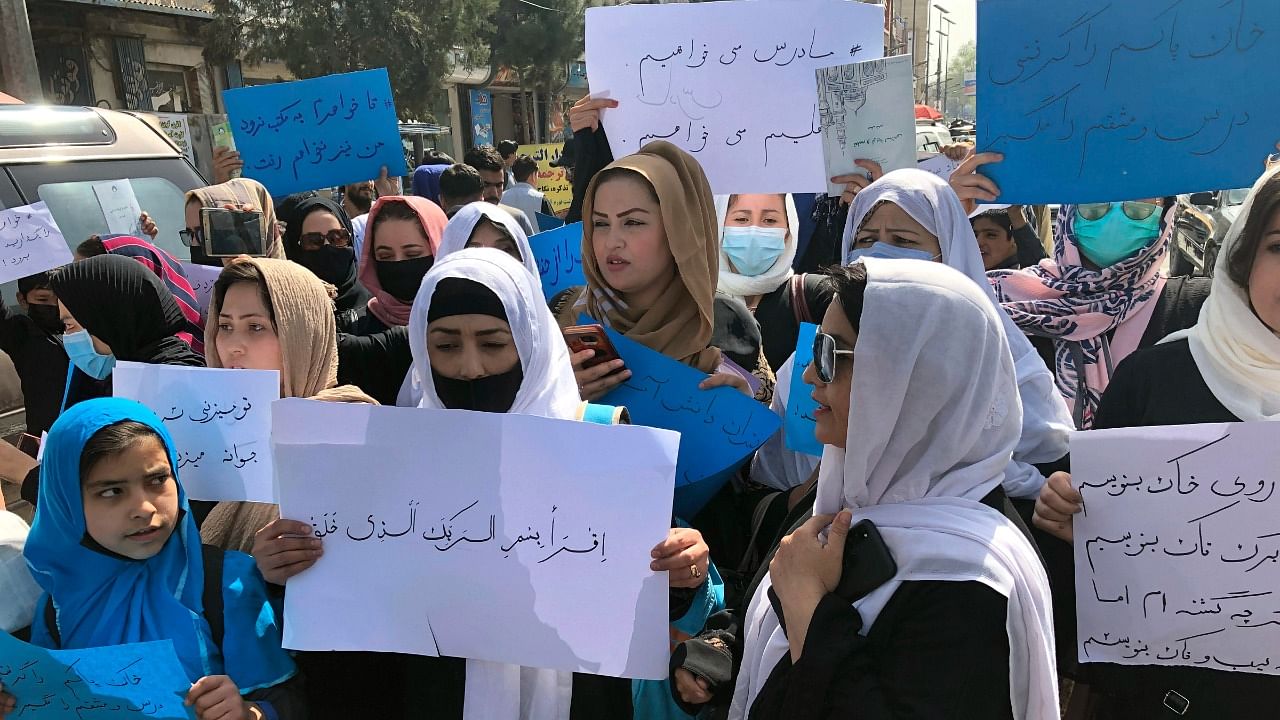 Afghan women chant and hold signs of protest during a demonstration in Kabul. Credit: AP/PTI Photo