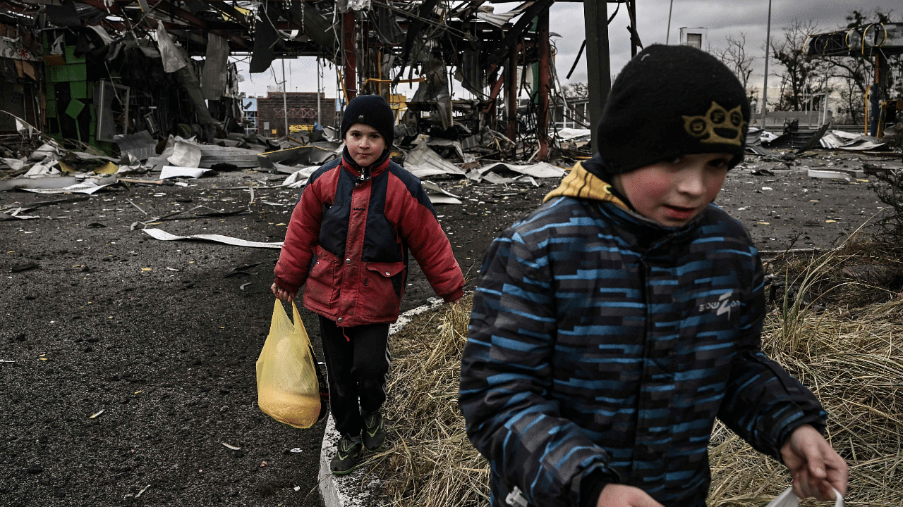 Children evacuate the city of Irpin, northwest of Kyiv, during heavy shelling and bombing. Credit: AFP Photo