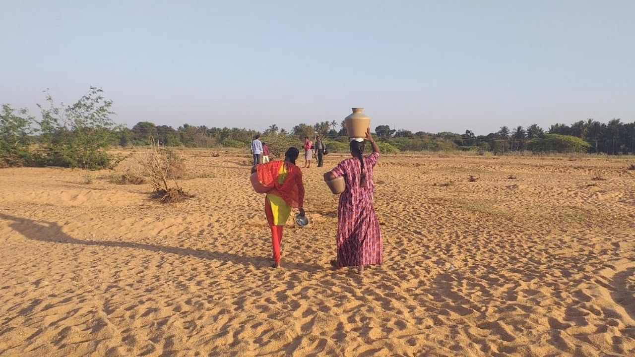 People walk to collect water.