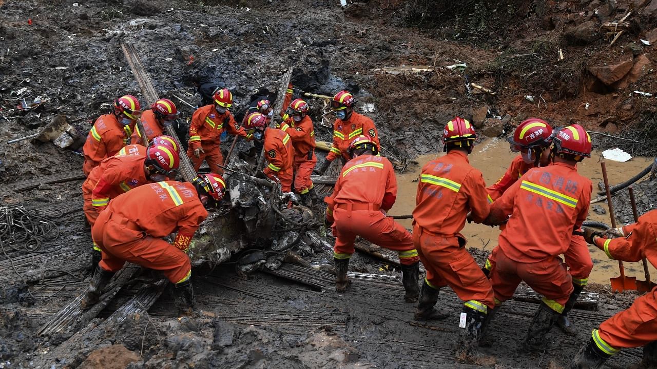 Search and rescue workers pull debris out from the mud at the China Eastern flight crash site in Tengxian County in southern China's Guangxi Zhuang Autonomous Region. Credit: AP/PTI Photo