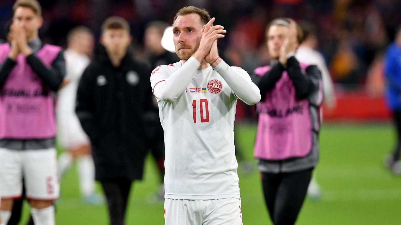 Christian Eriksen applauds the supporters. Credit: AFP Photo