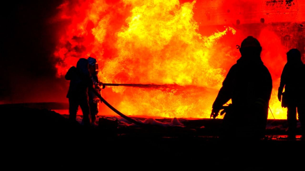 Firefighters putting out a fire after Russian missiles strikes to infrastructure including a fuel storage facility on the western Ukrainian city of Lviv. Credit: Handout / Ukrainian State Emergency Service / AFP