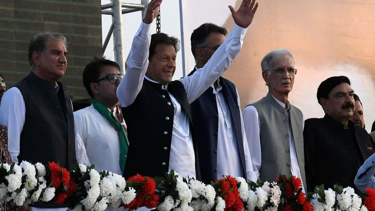 Pakistan's Prime Minister Imran Khan (C) along with other lawmakers, gestures upon his arrival to address the supporters of ruling Pakistan Tehreek-e-Insaf (PTI) party during a rally in Islamabad. Credit: AFP Photo