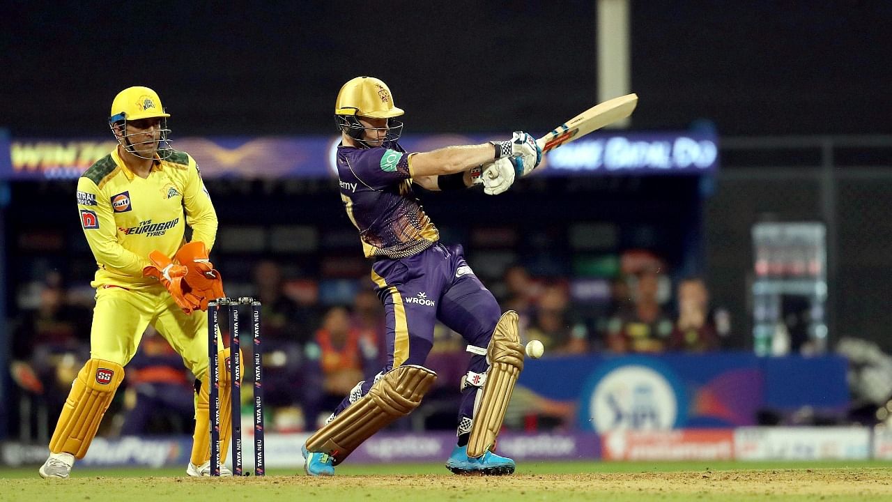 Sam Billings of KKR plays a shot as Dhoni looks on. Credit: PTI Photo