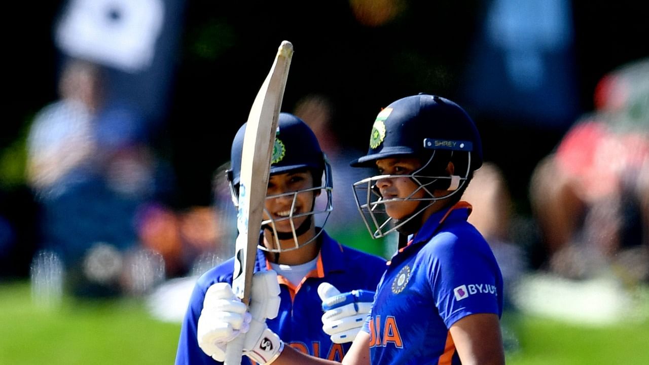 Shafali Verma (R) celebrates after scoring a half century as her teammate Smriti Mandhana looks on during the Women's Cricket World Cup match between South Africa and India at Hagley Oval in Christchurch. Credit: AFP Photo