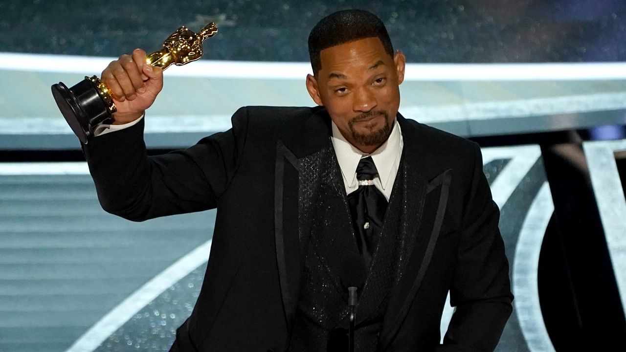 Will Smith accepts the award for best performance by an actor in a leading role for "King Richard" at the Oscars. Credit: AP Photo