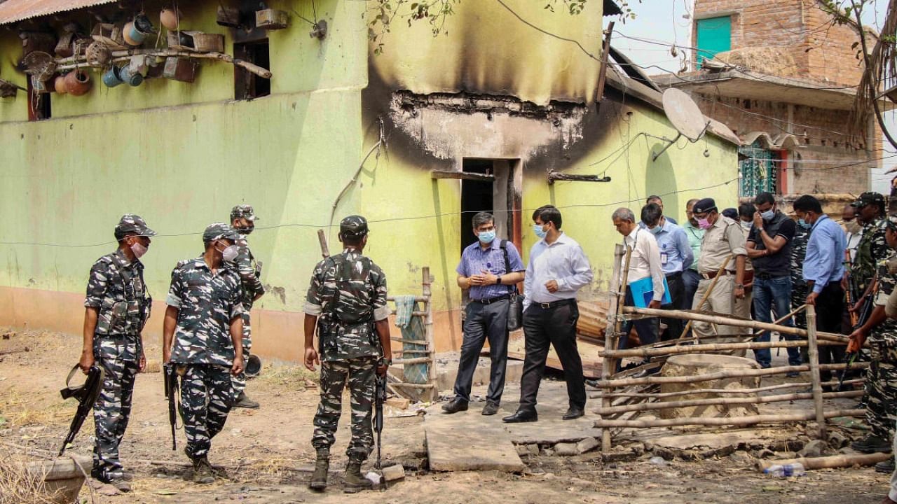 CBI officers with CFSL team investigate near the house where eight people were burnt alive, at Bogtui village in Birbhum district of West Bengal. Credit: PTI Photo