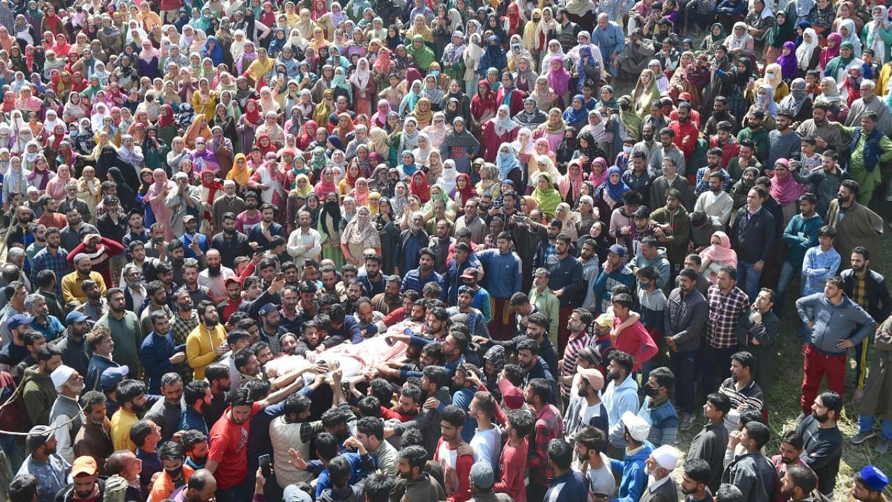  Locals mourn the death of a Special Police Officer (SPO) Ishfaq Ahmad and his brother Umar Jan, during their funeral at Chadbugh area of Budgam, Sunday, March 27, 2022. Militants on Saturday evening shot dead a SPO and injured his brother who later succumbed to injuries. Credit: PTI Photo