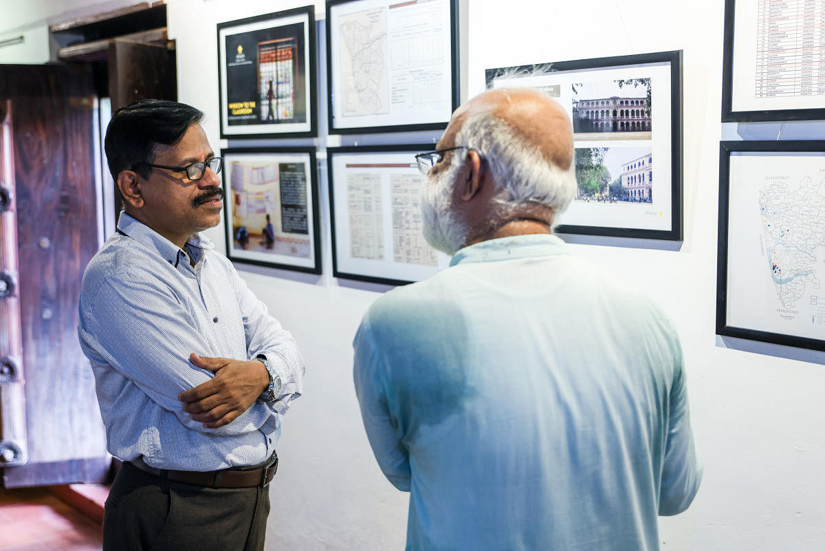 DDPI Sudhakar K interacts with Subhas Chandra Basu, Convener of INTACH, Mangaluru Chapter, during the exhibition at the Kodialguthu Centre for Art and Culture.