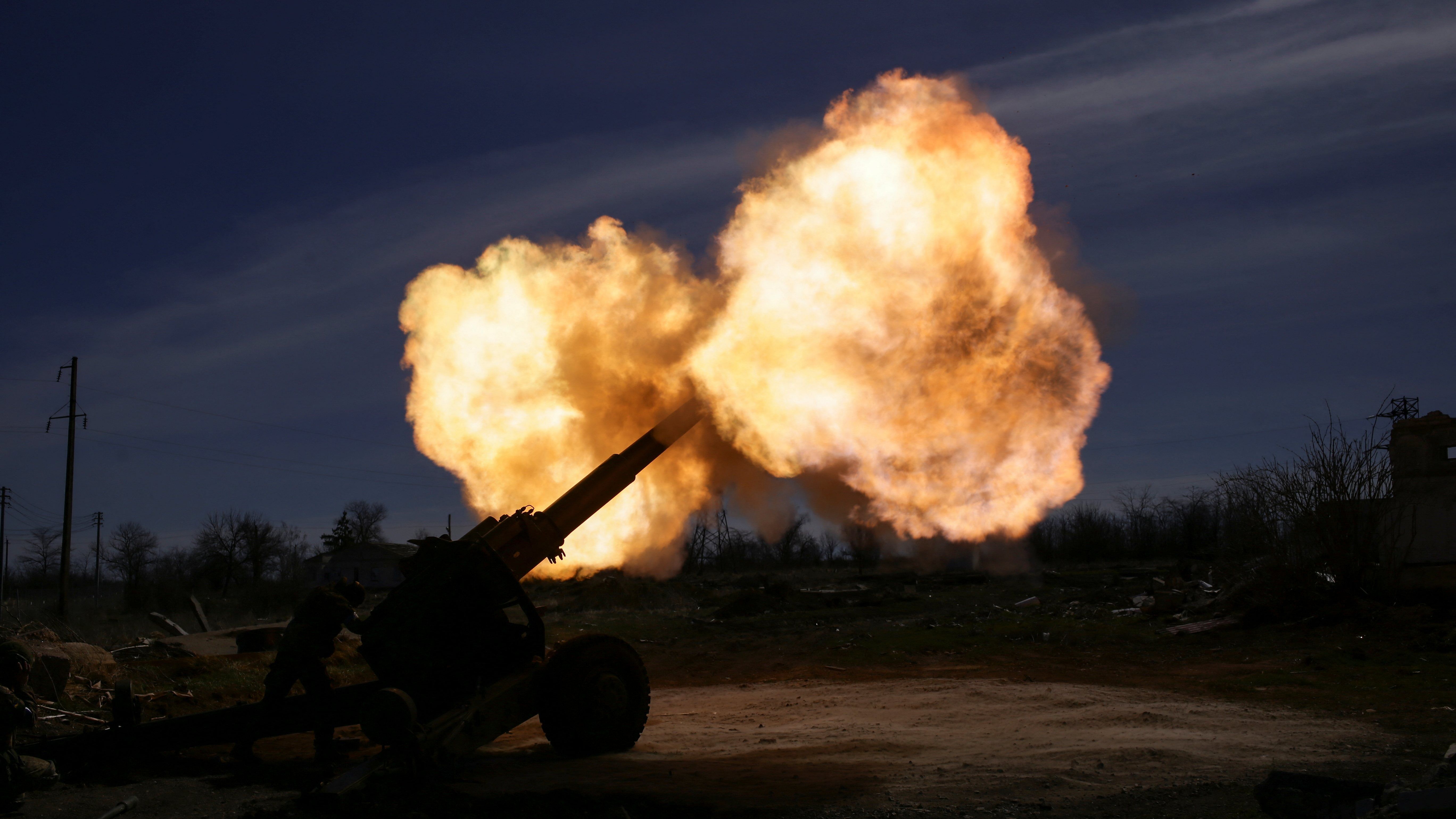 A member of the Ukrainian Volunteer Corps rests next to a howitzer, as Russia's attack on Ukraine continues, at a position in Zaporizhzhia region. credit: Reuters Photo