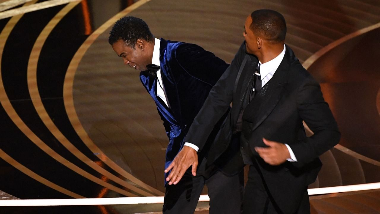 Will Smith (R) slaps Oscars host and comedian Chris Rock during the 2022 awards show. Credit: AFP Photo