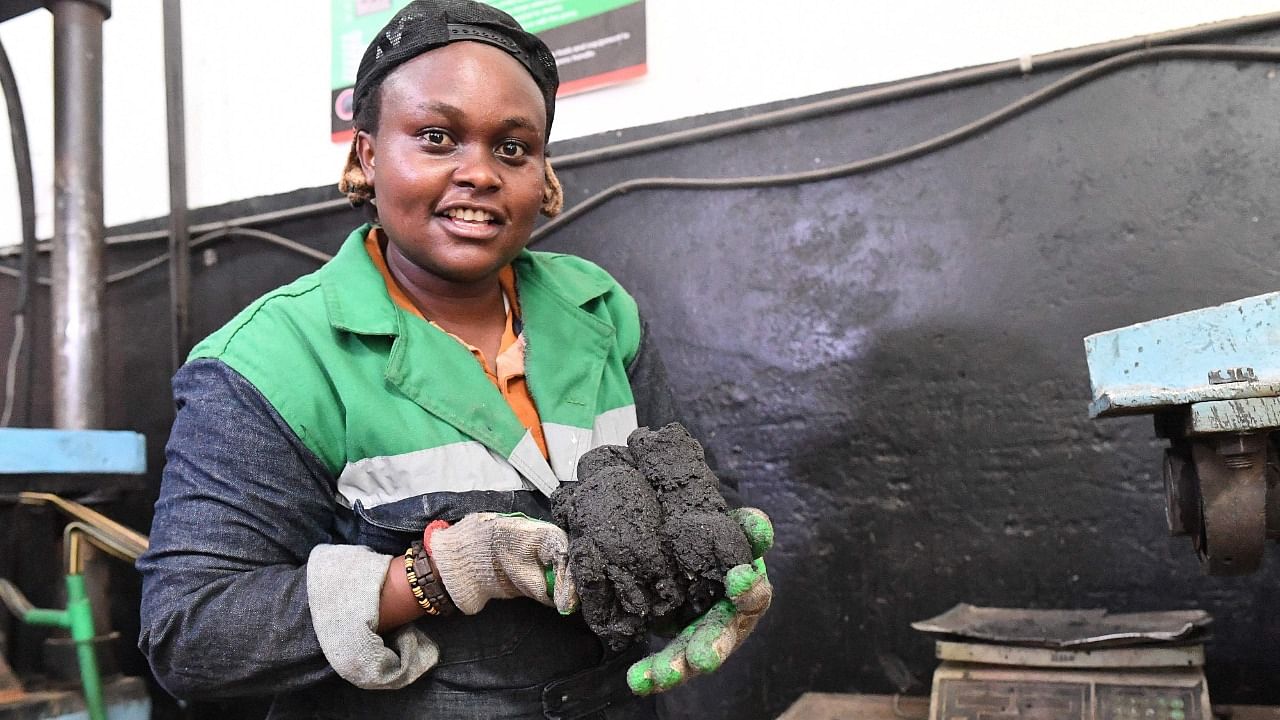 Kenyan Nzambi Matee, entrepreneur and inventor, holds extracted plastic polymer that is recycled to make bricks. Credit: AFP Photo