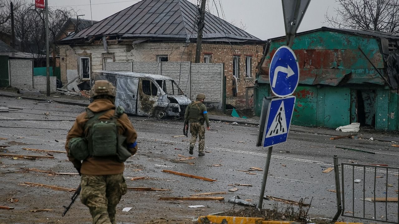 Ukrainian service members walk on the front line near Kyiv. Credit: Reuters Photo