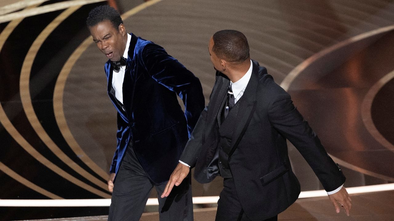Will Smith (R) hits Chris Rock as Rock spoke on stage during the 94th Academy Awards. Credit: Reuters Photo